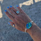 Abalone shell bangle bracelet – sterling silver hinged ocean-inspired jewelry with blue, purple, and green swirls