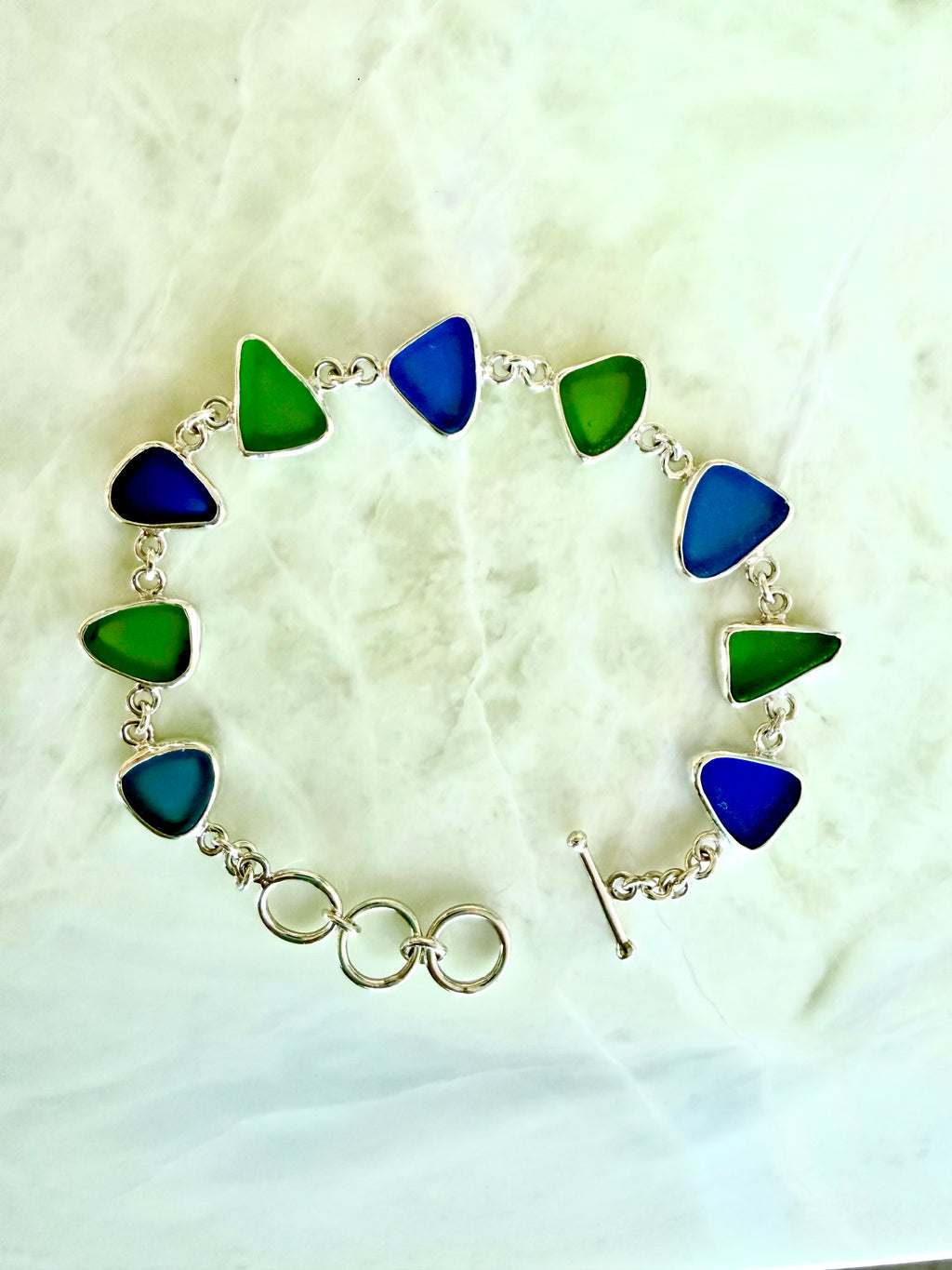 Sterling silver bracelet featuring cobalt blue and lime green sea glass from the Jersey Shore.