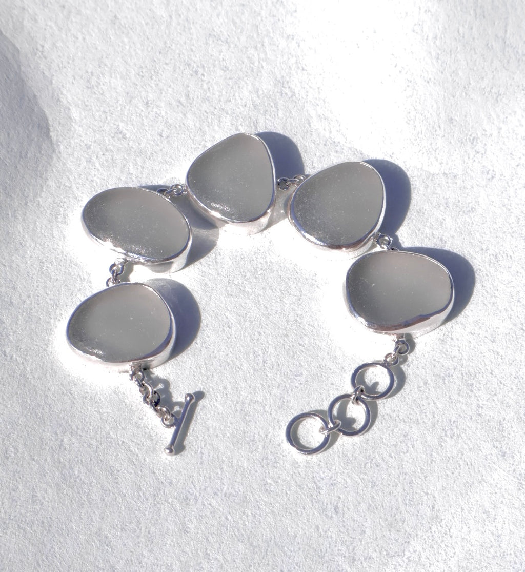 Sterling silver bracelet featuring five thick, frosted gray-lavender Sicilian sea glass pieces with adjustable clasp.