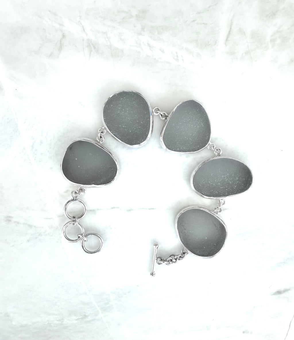 Sterling silver bracelet featuring five thick, frosted gray-lavender Sicilian sea glass pieces with adjustable clasp.