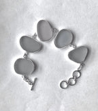 Sterling silver bracelet featuring thick gray Sicilian sea glass with a natural patina and adjustable clasp.
