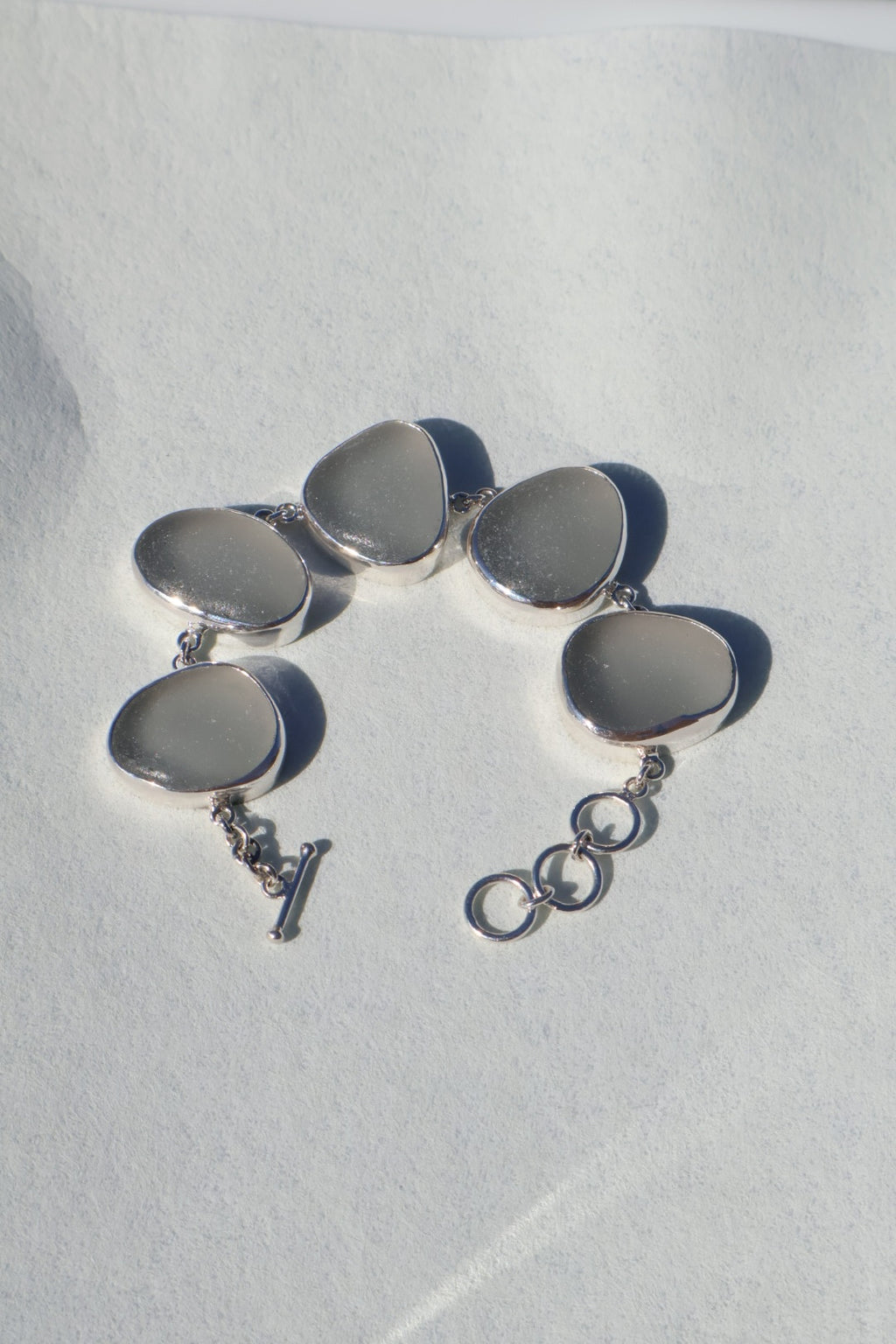 Sterling silver bracelet featuring thick gray Sicilian sea glass with a natural patina and adjustable clasp.