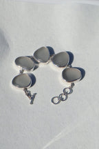 Sterling silver bracelet featuring thick gray Sicilian sea glass with a natural patina and adjustable clasp.