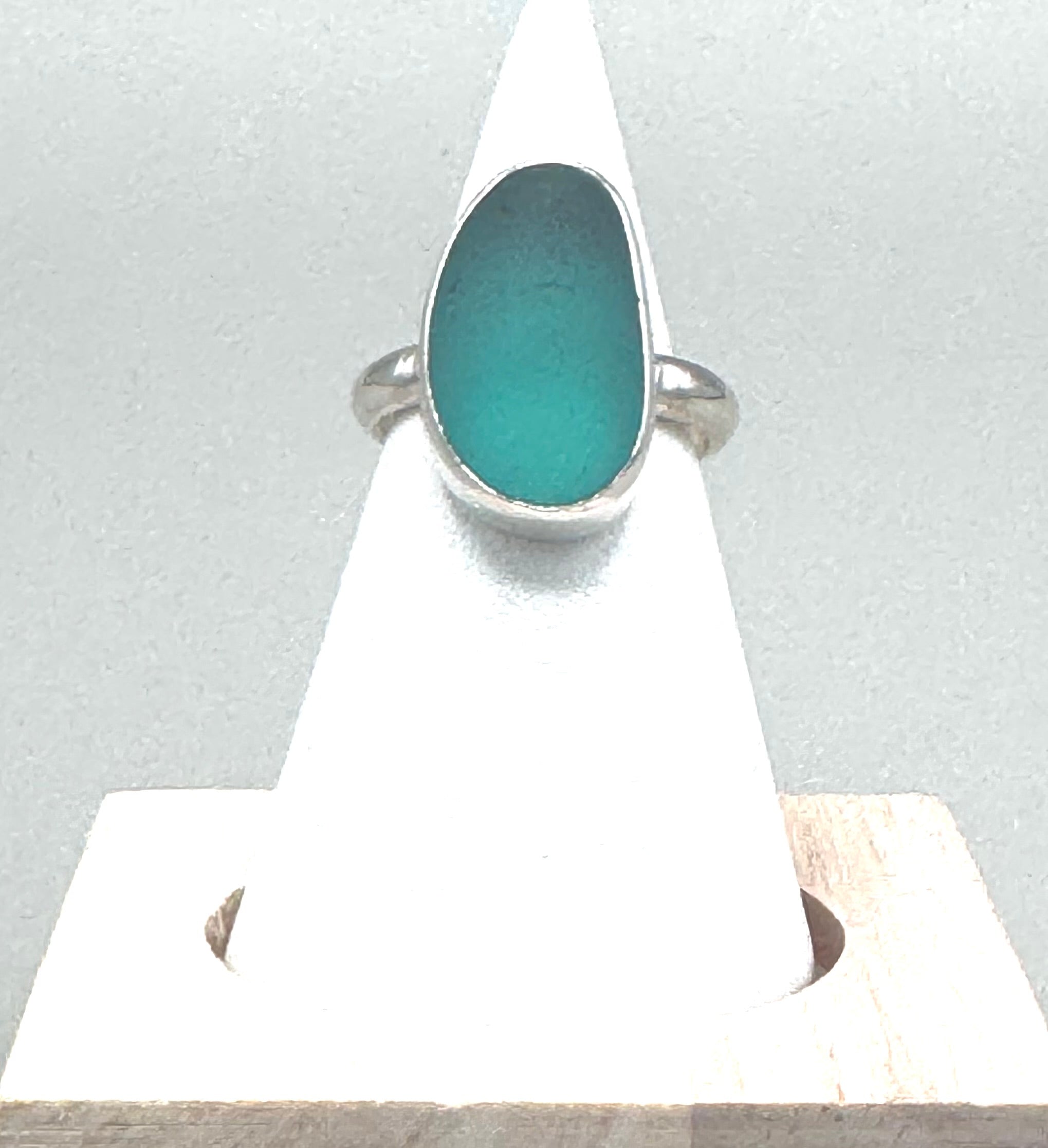 Sterling silver ring featuring smooth aquamarine Japanese sea glass from hand-blown fishing net floats.