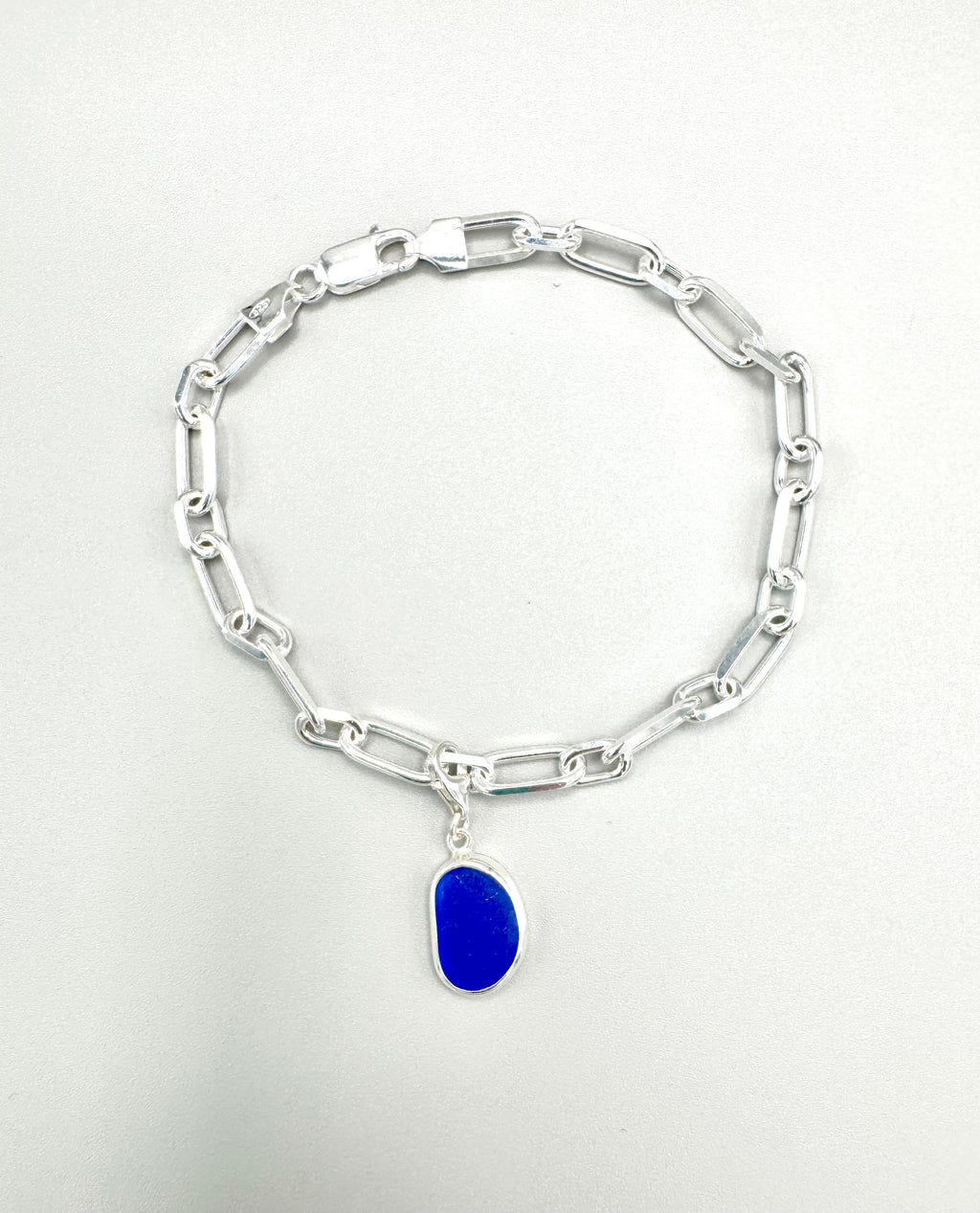 Sterling silver paperclip anklet with deep Mediterranean blue sea glass charm from Spain.