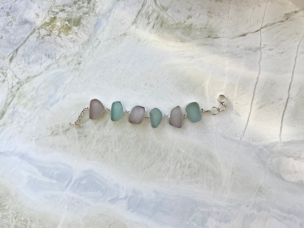 Sterling silver bracelet featuring pale blue and lavender sea glass from Glass Beach, Fort Bragg, California.