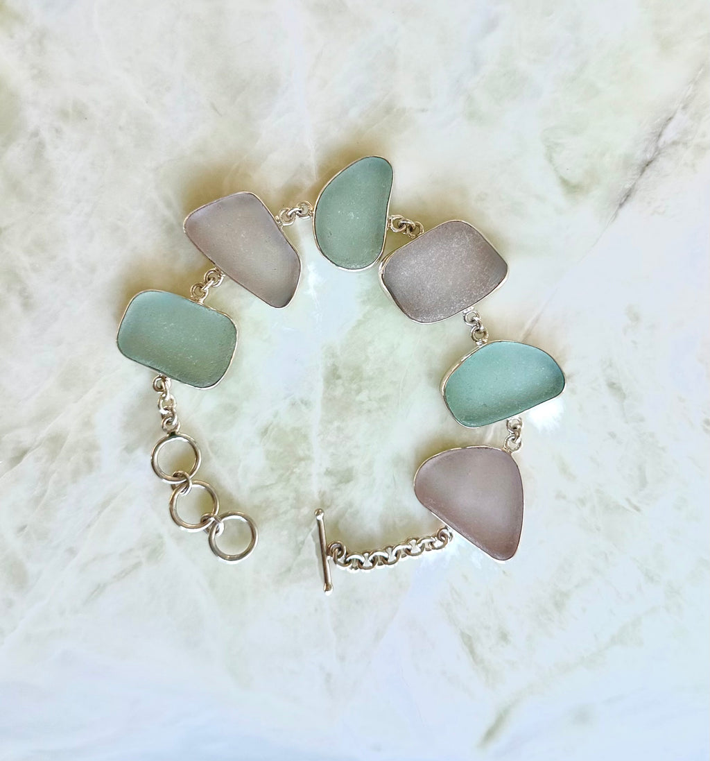 Sterling silver bracelet featuring pale blue and lavender sea glass from Glass Beach, Fort Bragg, California.