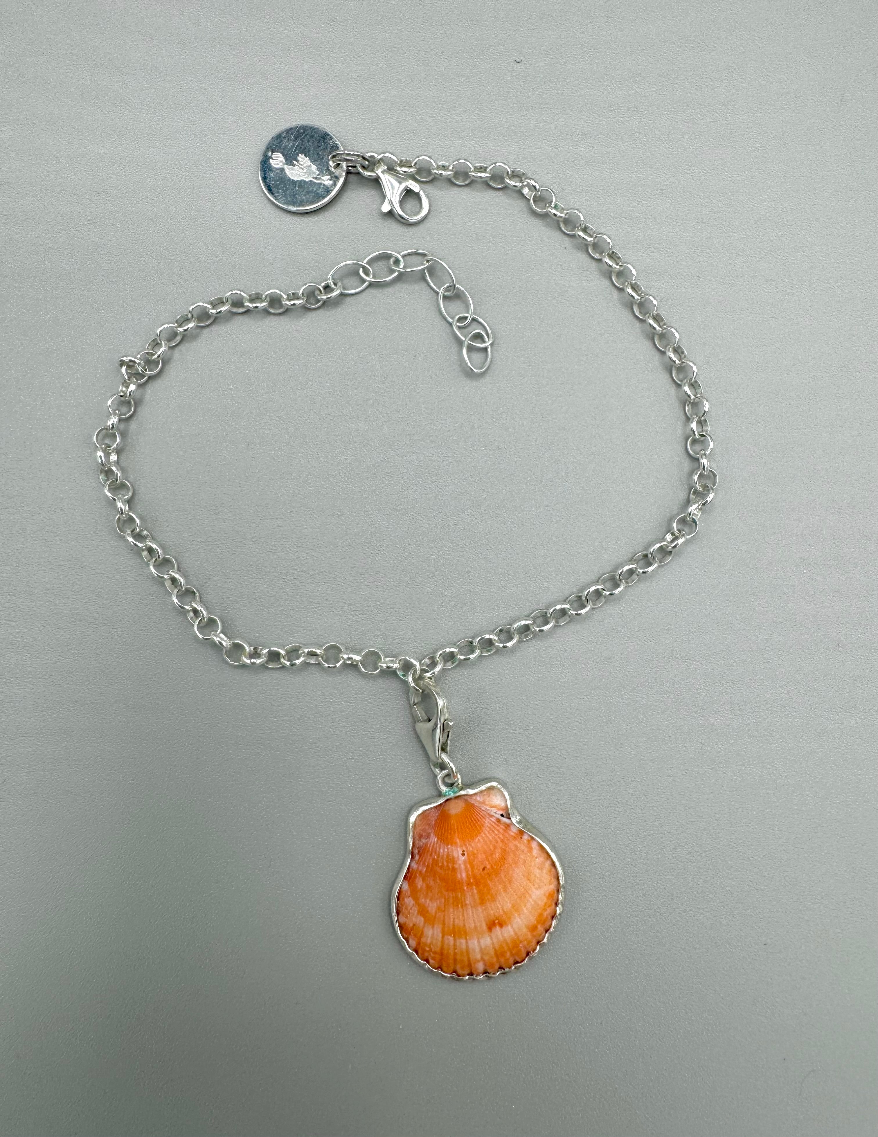 Sterling silver adjustable ankle bracelet featuring a pink scallop shell charm and swimming mermaid logo tag from southwest Florida.