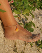 Sterling silver adjustable ankle bracelet featuring a pink scallop shell charm and swimming mermaid logo tag from southwest Florida.
