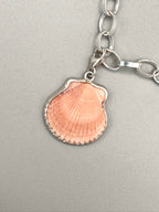 Sterling silver charm bracelet with pink scallop shell, fossilized shark tooth, and aquamarine sea glass from Japan — ocean-inspired handcrafted jewelry.