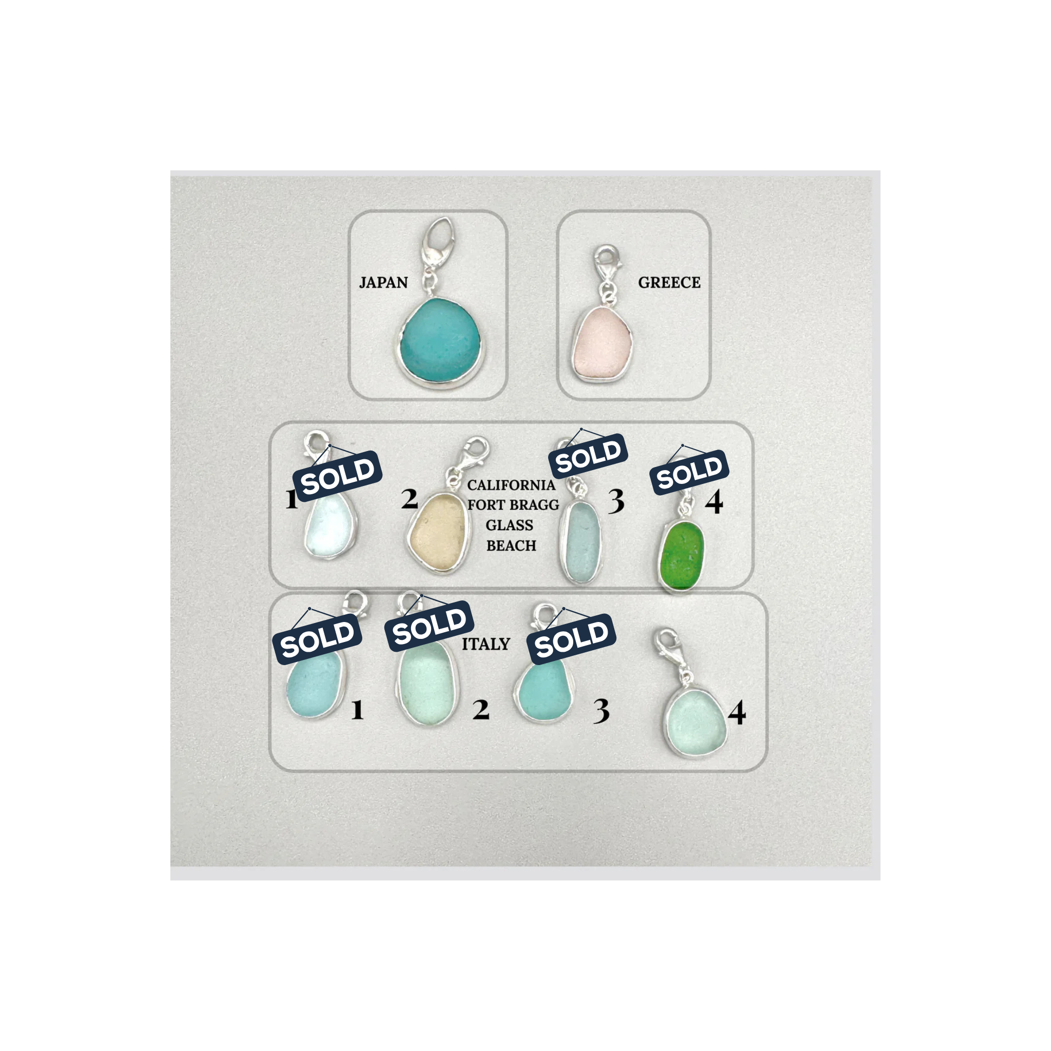 Set of colorful teardrop-shaped charms with 'SOLD' labels on a white background