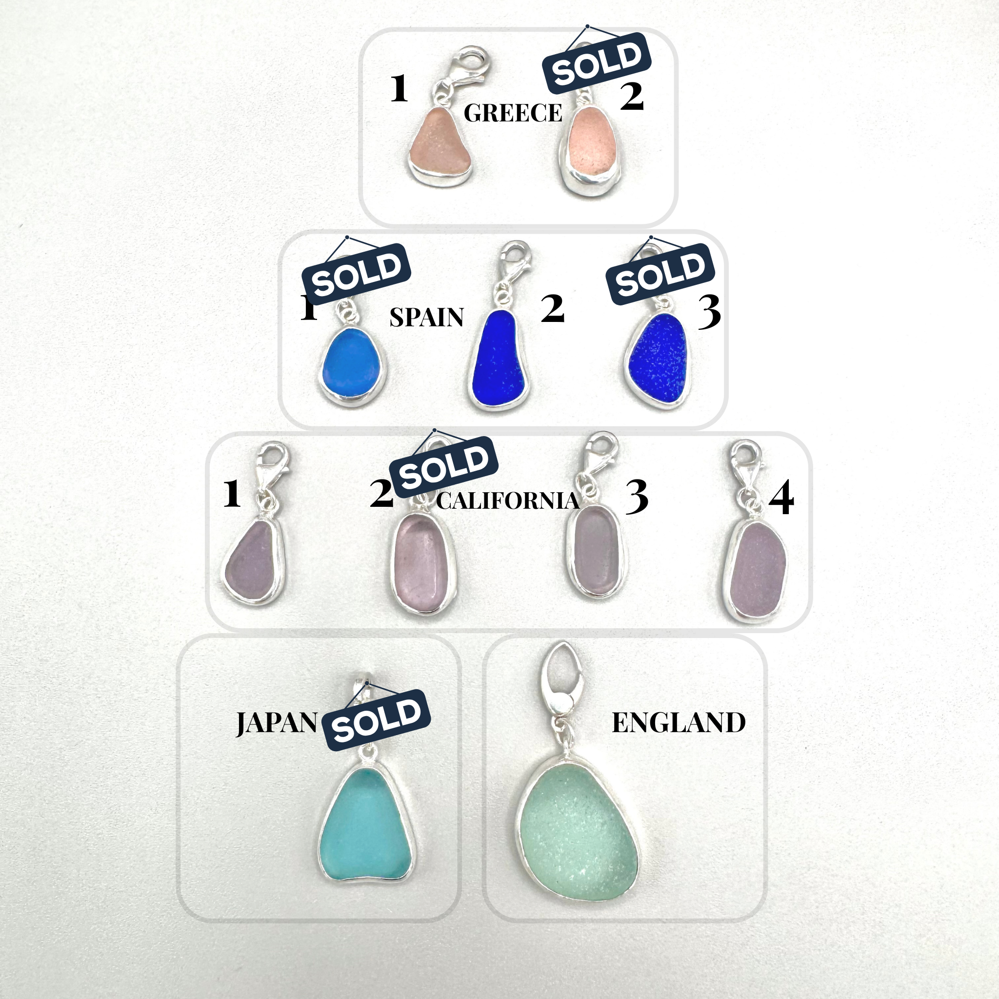 Collection of sea glass pendants with 'SOLD' labels on a white background
