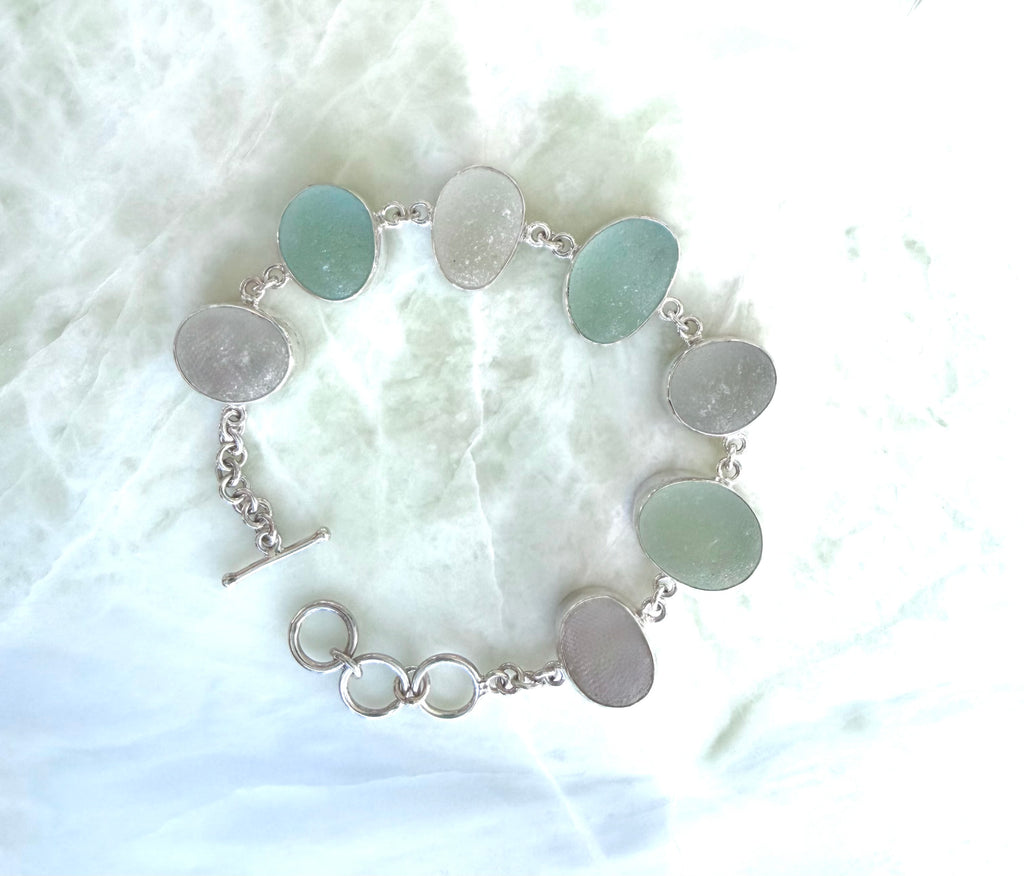 Sterling silver bracelet featuring seafoam and gray/white sea glass from the northeast coast of England
