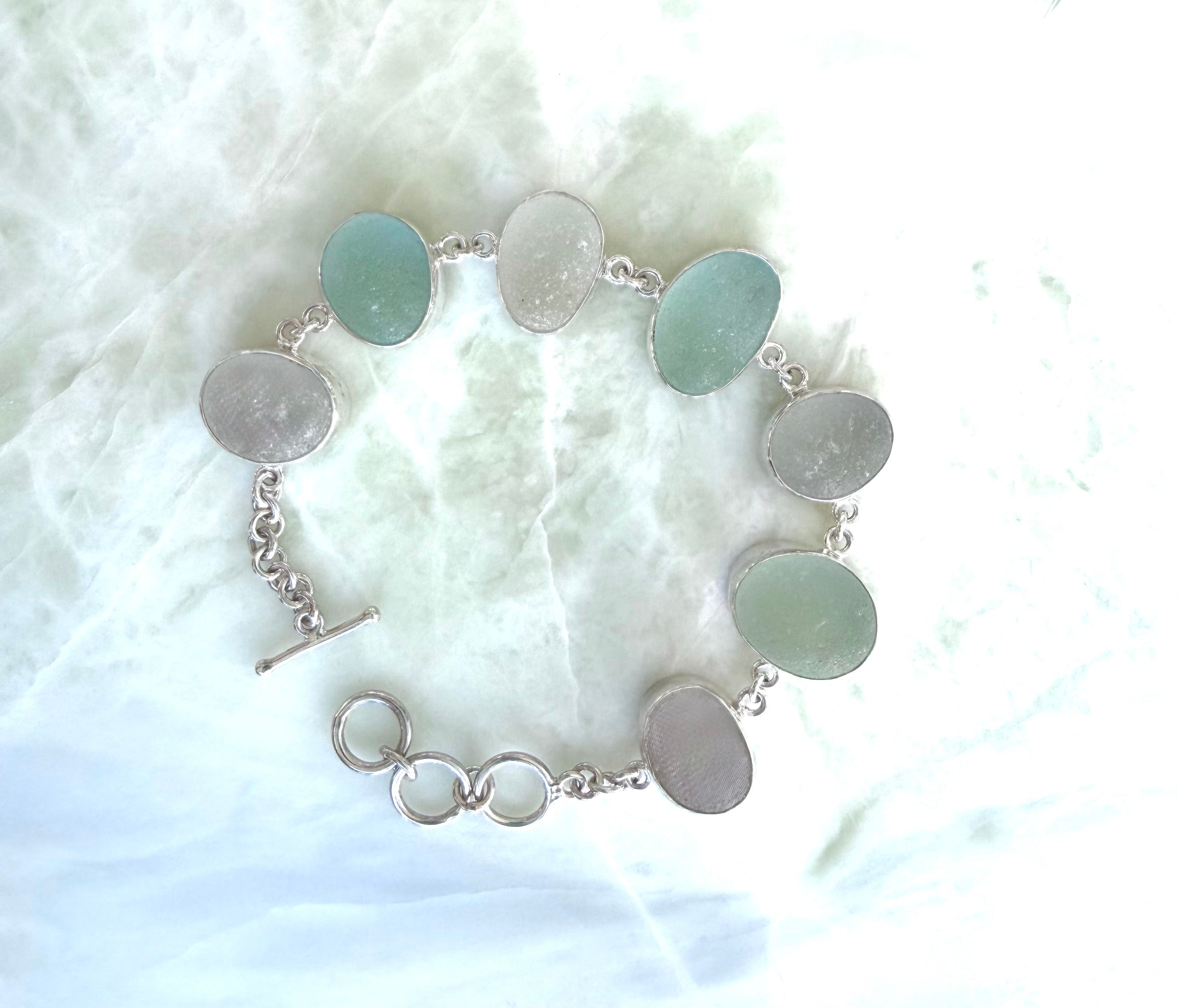 Sterling silver bracelet featuring seafoam and gray/white sea glass from the northeast coast of England