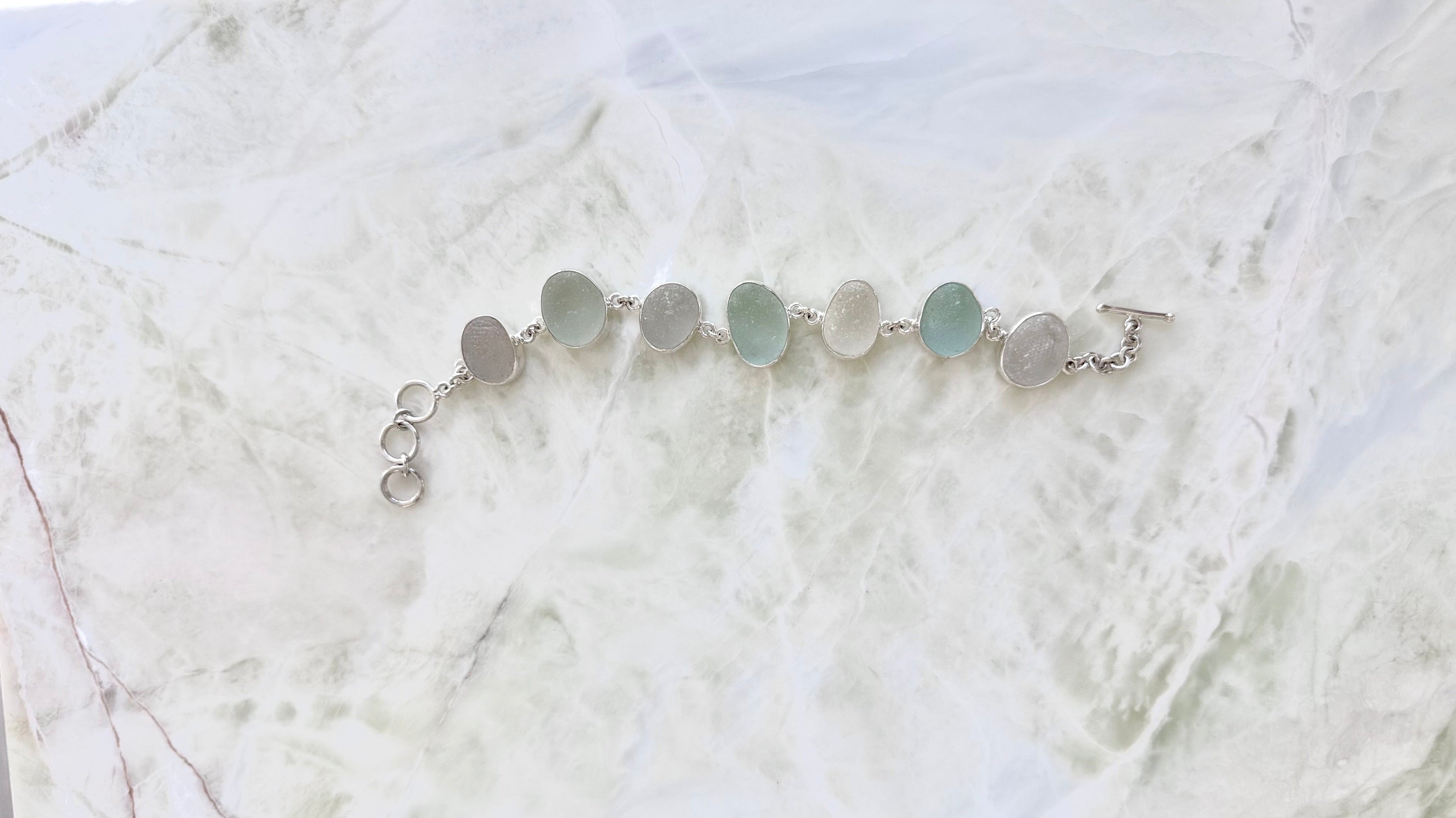 Sterling silver bracelet featuring seafoam and gray/white sea glass from the northeast coast of England