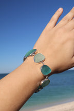 Sterling silver bracelet featuring alternating teal and sea foam Italian sea glass pieces with an adjustable clasp.