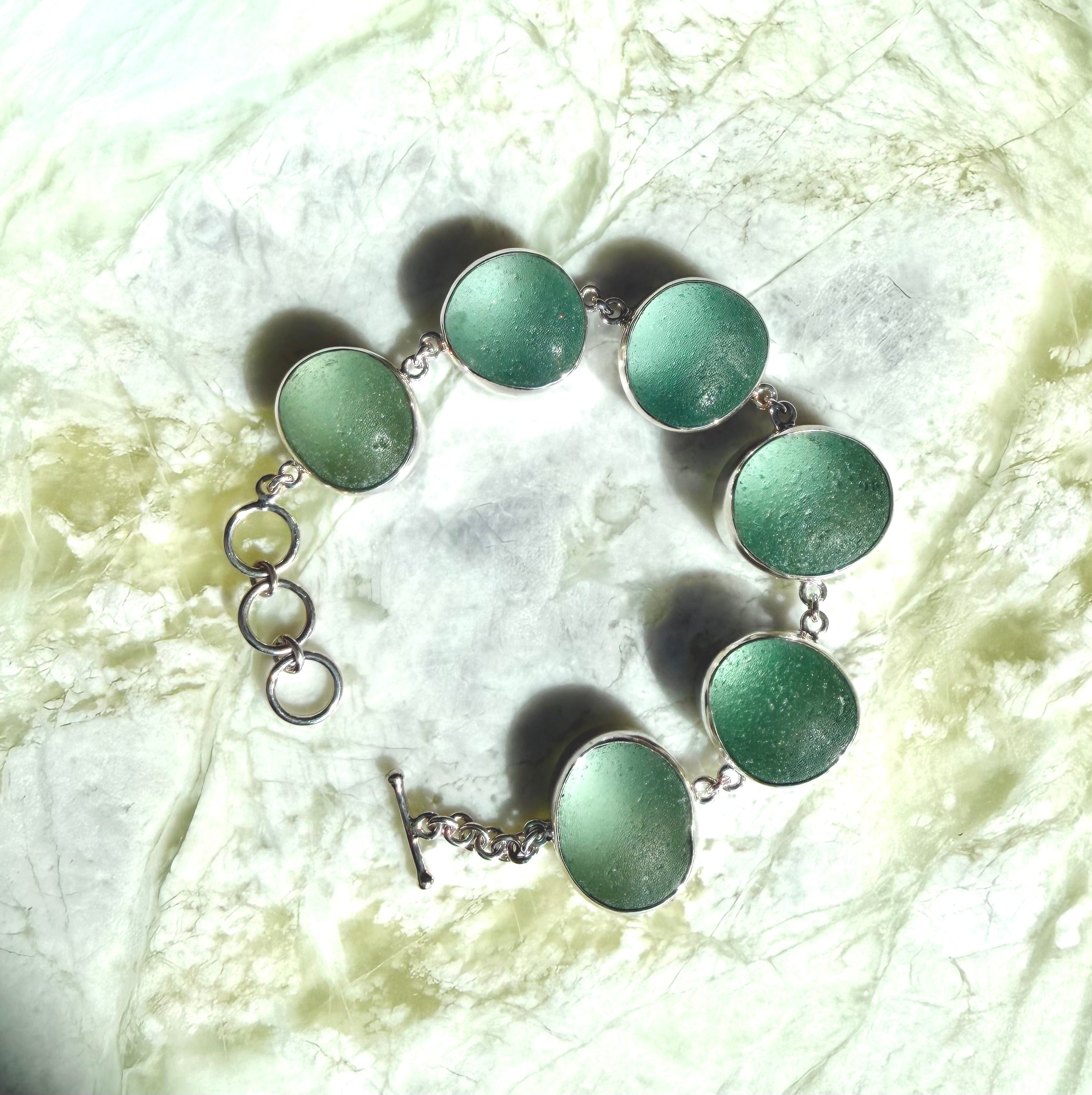 Sterling silver adjustable bracelet featuring antique seafoam green sea glass from the North Sea coast of England.