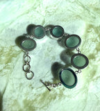 Sterling silver adjustable bracelet featuring antique seafoam green sea glass from the North Sea coast of England.