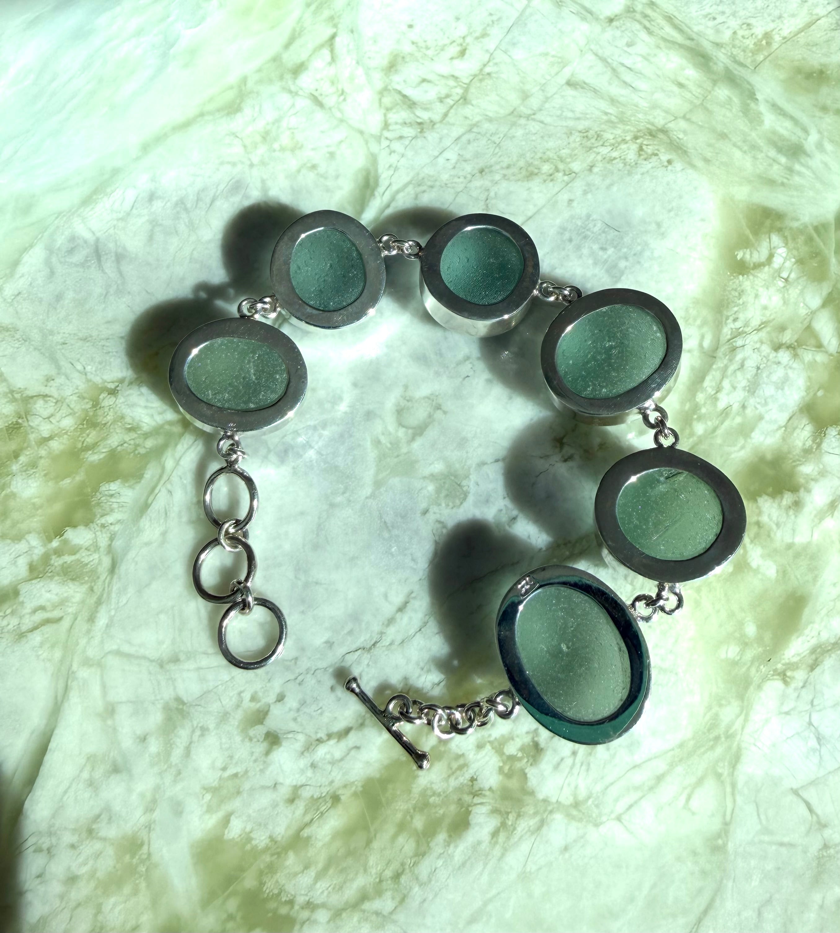 Sterling silver adjustable bracelet featuring antique seafoam green sea glass from the North Sea coast of England.